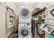 A convenient laundry room with a stacked washer and dryer, storage shelves, and space-saving design at 1884 Point River Dr, Duluth, GA 30097