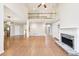 Open living space with stone fireplace, hardwood floors, and a view to the upstairs loft at 1884 Point River Dr, Duluth, GA 30097
