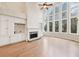 Elegant living room with built-in cabinets, fireplace, hardwood floors, and large windows at 1884 Point River Dr, Duluth, GA 30097