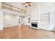 Cozy living room with a stone fireplace, built-in shelving, and beautiful hardwood floors at 1884 Point River Dr, Duluth, GA 30097
