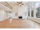 Bright living room featuring hardwood floors, a fireplace, built-in shelving, and large windows at 1884 Point River Dr, Duluth, GA 30097
