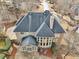 Aerial view of the rear of a home featuring a stone patio and sunroom at 1884 Point River Dr, Duluth, GA 30097