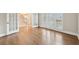 Bright room with wood floors, french doors, plantation shutters, and views to the foyer at 1884 Point River Dr, Duluth, GA 30097