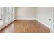 A light-filled room with white trim, neutral walls, wood floors, and french doors at 1884 Point River Dr, Duluth, GA 30097