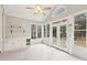 Bright sunroom with vaulted ceilings, tiled flooring, and multiple windows with backyard views at 1884 Point River Dr, Duluth, GA 30097