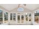 Sunroom featuring multiple windows, tiled flooring, and backyard views at 1884 Point River Dr, Duluth, GA 30097