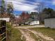 Quaint single-story home with ample yard space, outbuildings, and a circular driveway at 3310 Pilgrim Mill Rd, Cumming, GA 30041