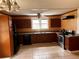 Spacious kitchen featuring dark cabinets, tile flooring, and stainless steel appliances at 3310 Pilgrim Mill Rd, Cumming, GA 30041