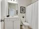 Clean bathroom with a shower-tub combo, white vanity, toilet, and decorative accents at 3891 Shelleydale Dr, Powder Springs, GA 30127
