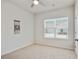 Cozy bedroom with neutral walls, carpet flooring, ceiling fan and a view of the neighborhood through a large window at 3891 Shelleydale Dr, Powder Springs, GA 30127