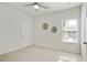 Bright bedroom featuring carpet flooring, a window, and decorative wall accents at 3891 Shelleydale Dr, Powder Springs, GA 30127