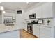Modern kitchen featuring white cabinetry, stainless steel appliances, and granite countertops at 3891 Shelleydale Dr, Powder Springs, GA 30127