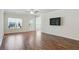 Open living room showcasing hardwood floors, bright natural light, and a mounted television at 3891 Shelleydale Dr, Powder Springs, GA 30127