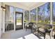 Inviting screened porch with comfortable seating, an outdoor rug, and a view of the surrounding landscape at 3891 Shelleydale Dr, Powder Springs, GA 30127