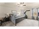 Bright main bedroom with tray ceiling, ceiling fan, and large windows at 3940 Village Estates Ct, Cumming, GA 30040