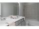 Bright bathroom featuring double sinks, quartz countertop and tiled shower over tub at 600 Belshire Dr, Acworth, GA 30102