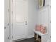 Organized mudroom entryway with bench seating, storage baskets, coat hooks, and dark wood-look flooring at 600 Belshire Dr, Acworth, GA 30102