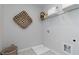 Functional laundry room space featuring tile flooring, storage shelf and laundry sink basin at 600 Belshire Dr, Acworth, GA 30102