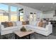 Open concept living room with large sectional sofa and backyard view at 600 Belshire Dr, Acworth, GA 30102