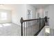 Bright loft area with carpet flooring, railing, and natural light provides a versatile living space at 600 Belshire Dr, Acworth, GA 30102
