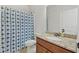 Well-lit bathroom featuring a granite countertop and a blue patterned shower curtain at 112 Standford Dr, Mcdonough, GA 30252
