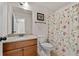 Cozy bathroom features a granite countertop, framed mirror, and shower with stylish floral shower curtain at 112 Standford Dr, Mcdonough, GA 30252