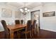 Elegant dining room featuring a coffered ceiling, hardwood floors, and stylish decor at 112 Standford Dr, Mcdonough, GA 30252