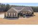Charming single-story home featuring a manicured lawn, brick accents, and a welcoming front porch at 112 Standford Dr, Mcdonough, GA 30252
