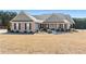 Charming single-story home featuring a manicured lawn, brick accents, and a welcoming front porch at 112 Standford Dr, Mcdonough, GA 30252
