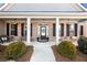 Inviting front porch with classic columns and well-maintained landscaping at 112 Standford Dr, Mcdonough, GA 30252