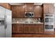Gourmet kitchen featuring stainless steel appliances, custom cabinetry, and a gas cooktop at 112 Standford Dr, Mcdonough, GA 30252