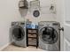 Well-equipped laundry room with stainless steel washer and dryer, plus shelving for storage at 112 Standford Dr, Mcdonough, GA 30252