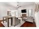 Bright living room featuring hardwood floors, a fireplace, high ceilings, and comfortable furniture at 112 Standford Dr, Mcdonough, GA 30252