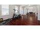 Open living space with hardwood flooring and featuring an exercise machine near the window at 112 Standford Dr, Mcdonough, GA 30252