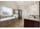 Main bathroom featuring a soaking tub, walk-in shower, and granite countertops at 112 Standford Dr, Mcdonough, GA 30252