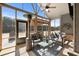 Relaxing screened-in patio with comfortable seating, ceiling fan, and a view of the backyard at 112 Standford Dr, Mcdonough, GA 30252