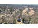 An aerial view of a brick home with a tree-lined lot in a beautiful neighborhood at 7455 Richmond Way, Cumming, GA 30040