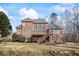 The spacious backyard features a deck with stairs, large windows, and a well-maintained lawn at 7455 Richmond Way, Cumming, GA 30040