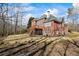Expansive backyard featuring a deck, large grassy area, and privacy provided by mature trees at 7455 Richmond Way, Cumming, GA 30040