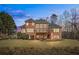 The backyard has a large deck and a lush green lawn, perfect for relaxing or entertaining guests at 7455 Richmond Way, Cumming, GA 30040