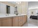 Bathroom vanity featuring double sinks, plenty of counter space, and access to an adjoining bedroom at 7455 Richmond Way, Cumming, GA 30040