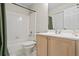 Clean bathroom with a tub/shower combination, tiled walls, and a vanity with ample storage at 7455 Richmond Way, Cumming, GA 30040