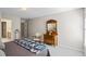 Inviting bedroom features a quilt-draped bed, dresser with mirror, a chair, and carpeted floor at 7455 Richmond Way, Cumming, GA 30040