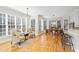 Sunny dining area with lots of windows, hardwood floors, and modern lighting at 7455 Richmond Way, Cumming, GA 30040