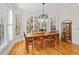 Dining room featuring hardwood floors, large windows, and a stylish light fixture at 7455 Richmond Way, Cumming, GA 30040