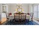 Formal dining room with elegant chandelier, hardwood floors, and neutral decor at 7455 Richmond Way, Cumming, GA 30040