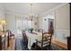 Bright dining room featuring hardwood floors, wainscoting, and a large window at 7455 Richmond Way, Cumming, GA 30040