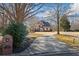 Charming brick home features a well-manicured lawn and a long driveway leading to the entrance at 7455 Richmond Way, Cumming, GA 30040