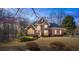 Lovely two-story brick home with manicured lawn, lush landscaping, and classic architectural details at 7455 Richmond Way, Cumming, GA 30040
