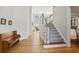 Bright foyer with hardwood floors, staircase, and soaring ceilings at 7455 Richmond Way, Cumming, GA 30040